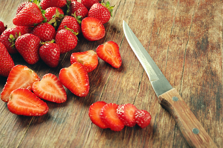 Tasty strawberries with knife on cutting board, closeupの写真素材