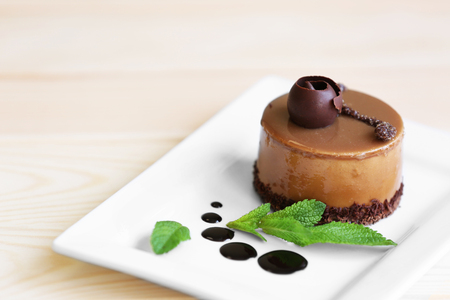 Caramel cake with tea on wooden tableの写真素材