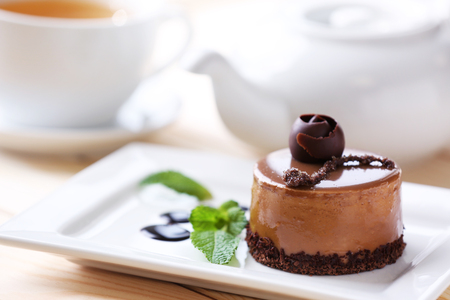 Caramel cake with tea on wooden tableの写真素材