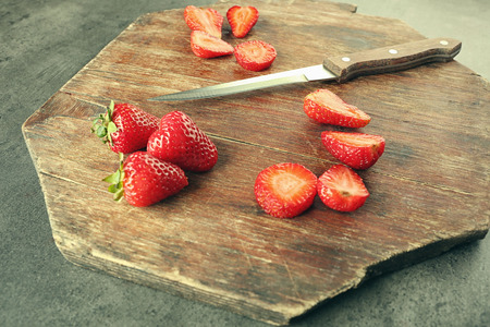 Tasty strawberries with knife on cutting board, closeupの写真素材