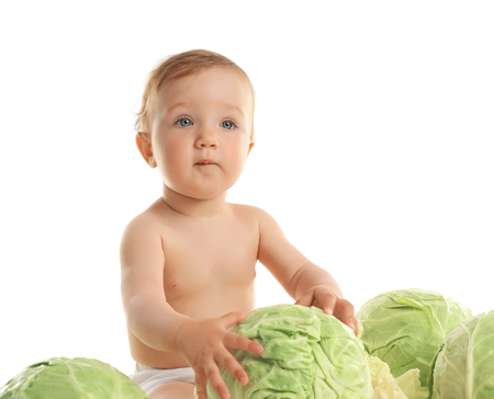 Cute baby girl with cabbage, isolated on whiteの写真素材
