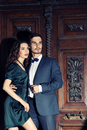 Elegant couple on old wooden door backgroundの写真素材