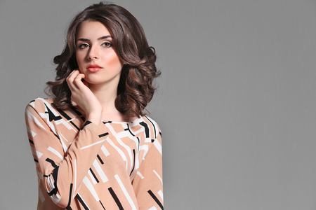 Pretty woman on grey backgroundの写真素材