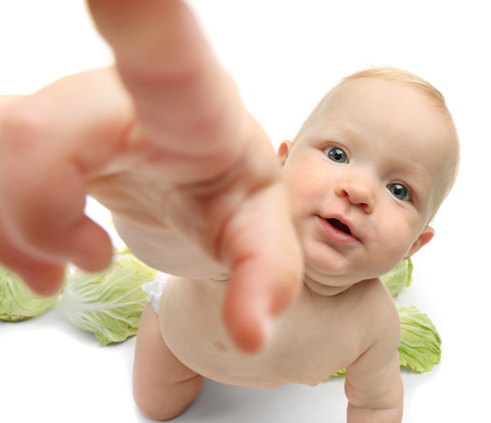 Beautiful baby and green cabbage on white backgroundの写真素材