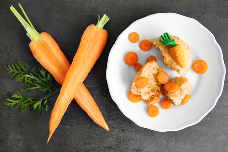 Carrot muffin in plate on dark backgroundの写真素材