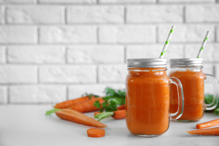 Fresh carrot juice on light backgroundの写真素材