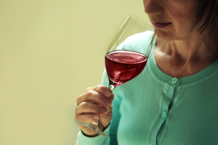 Woman tasting red wineの写真素材