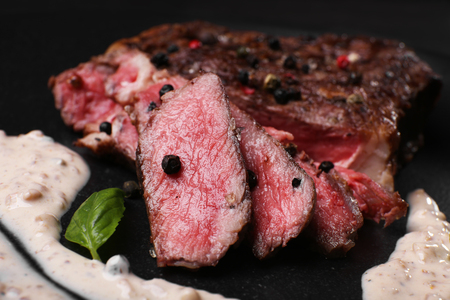 Sliced tasty steak with spices and sauce, closeupの写真素材