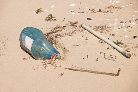 Polluted with trash sand shoreの写真素材