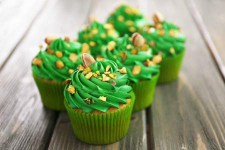 Green pistachio cupcakes on wooden backgroundの写真素材