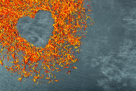 Saffron with heart silhouette on gray backgroundの写真素材
