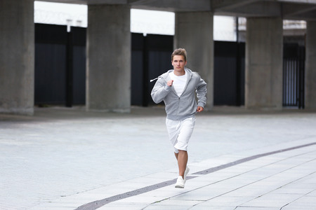 Young man running on the street