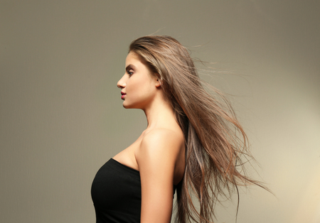 Young woman with healthy hair on light backgroundの写真素材