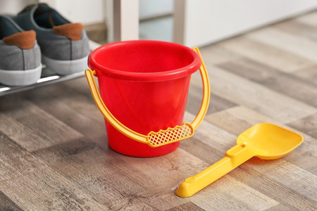 Children bucket and shovel on wooden floorの写真素材