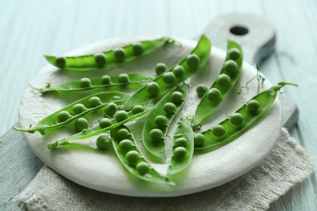 Fresh green peas on a plateの写真素材