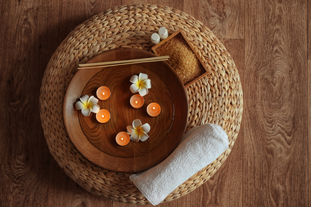 Beautiful spa composition with small lighted candles on wooden backgroundの写真素材