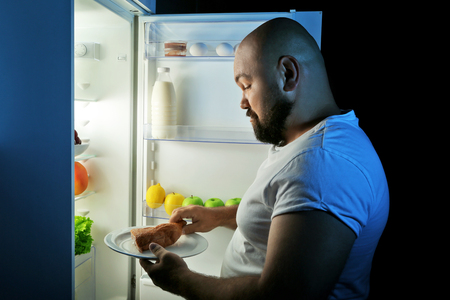 Man taking food from refrigeratorの写真素材
