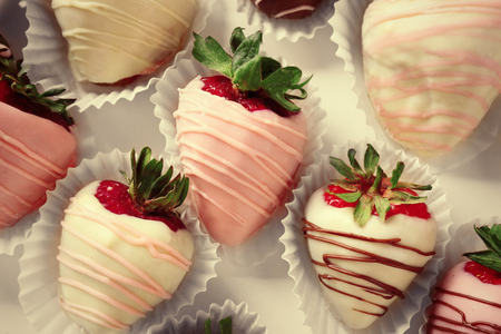 Strawberries covered with different chocolate in box, close upの写真素材