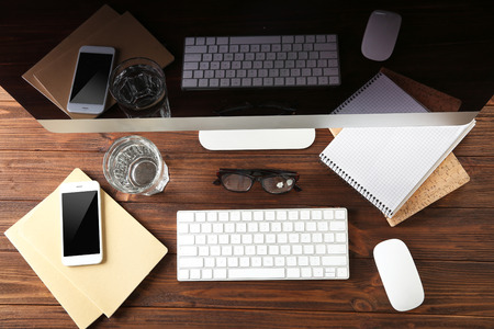 Modern workplace with keyboard and phone, top viewの写真素材