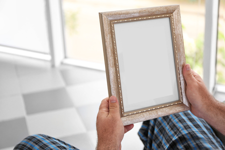 Man holding and looking at photoの写真素材