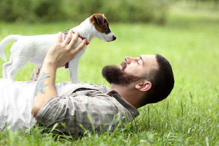 Man with cute dog in spring parkの写真素材