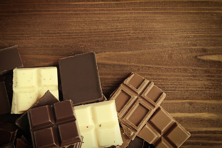 Chopped chocolate bars on wooden backgroundの写真素材