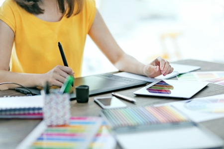 Designer workplace. Woman using tabletの写真素材