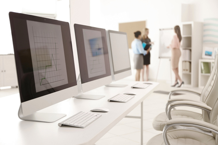 Modern computers and businesswomen at the meetingの写真素材