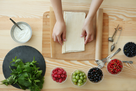 Woman making berry dessert, top viewの写真素材