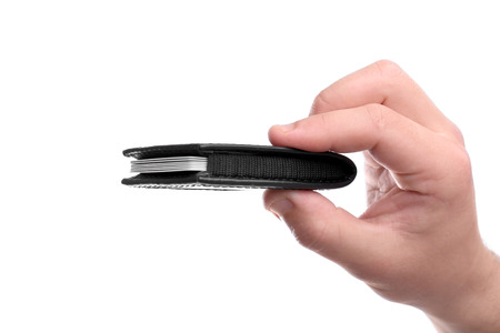 Male hand holding credit card holder, isolated on whiteの写真素材