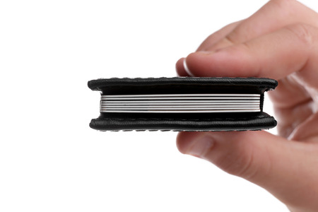 Male hand holding credit card holder, isolated on white