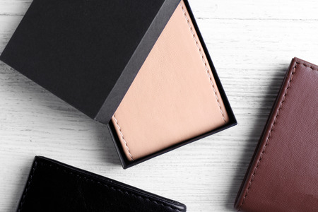 Leather wallets on wooden background
