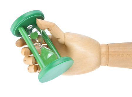 Wooden hand holding hourglass on white background