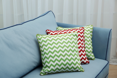 Comfortable sofa with pillows in the roomの写真素材