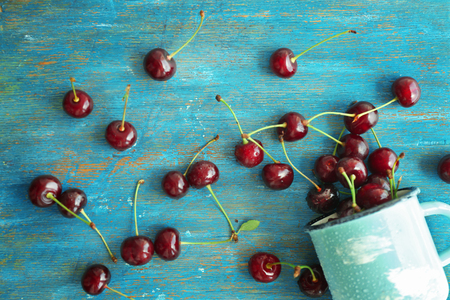 Fresh ripe cherries on blue wooden backgroundの写真素材