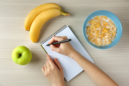 Woman counting calories, top viewの写真素材