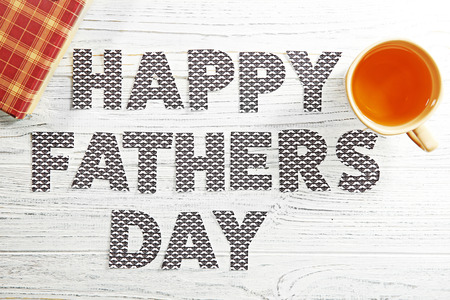 Happy Father's Day concept. Cup of tea and gift box on wooden backgroundの写真素材