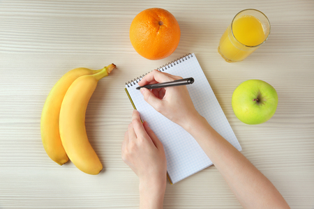 Woman counting calories, top viewの写真素材