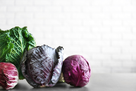 Different kinds of cabbage on brick wall backgroundの写真素材