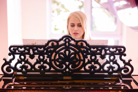 Beautiful girl playing pianoの写真素材