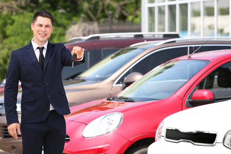 Man with car key outdoorsの写真素材