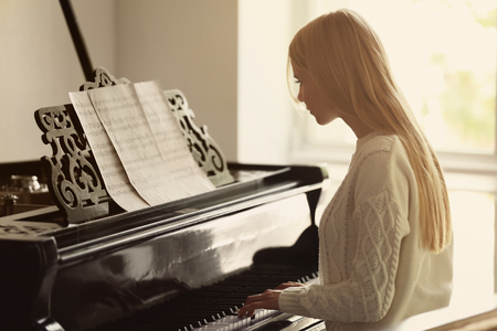 Girl playing pianoの写真素材