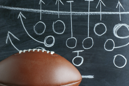 American football game strategy written with chalk on blackboardの写真素材