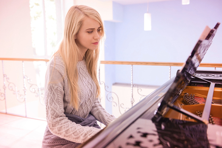 Beautiful girl playing pianoの写真素材