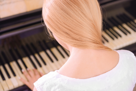 Girl playing pianoの写真素材