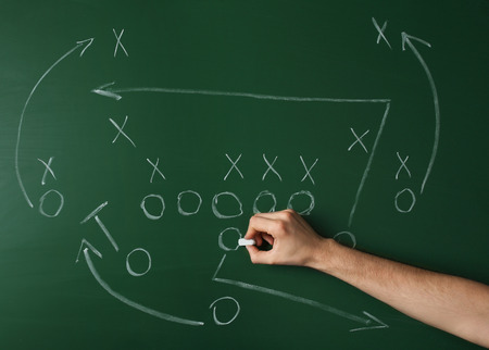 American football game strategy written with chalk on blackboardの写真素材