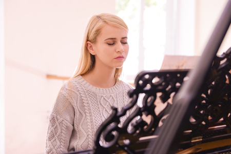 Beautiful girl playing pianoの写真素材
