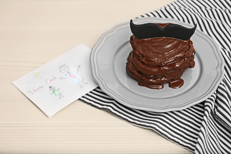 Chocolate pancakes with mustache and paint on table. Happy fathers day conceptの写真素材
