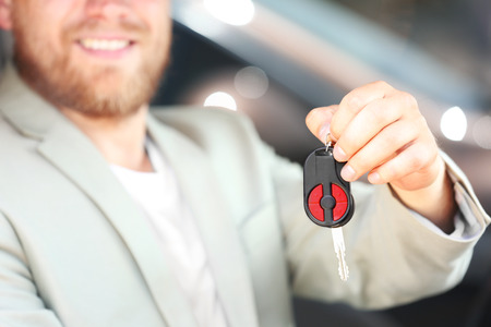Man holding key inside carの写真素材