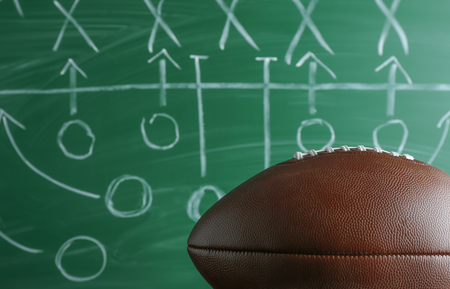 American football game strategy written with chalk on blackboardの写真素材